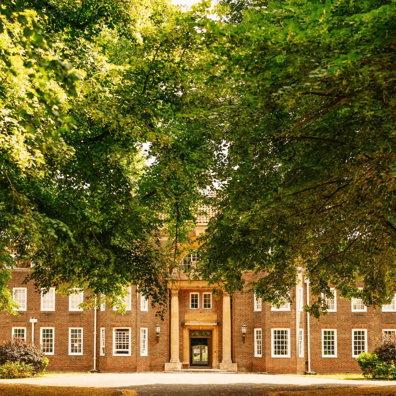 School entrance surrounded by trees
